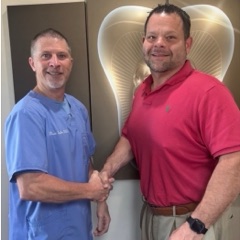 Dr. Todd Taylor shaking hands with Luxissimo's founder